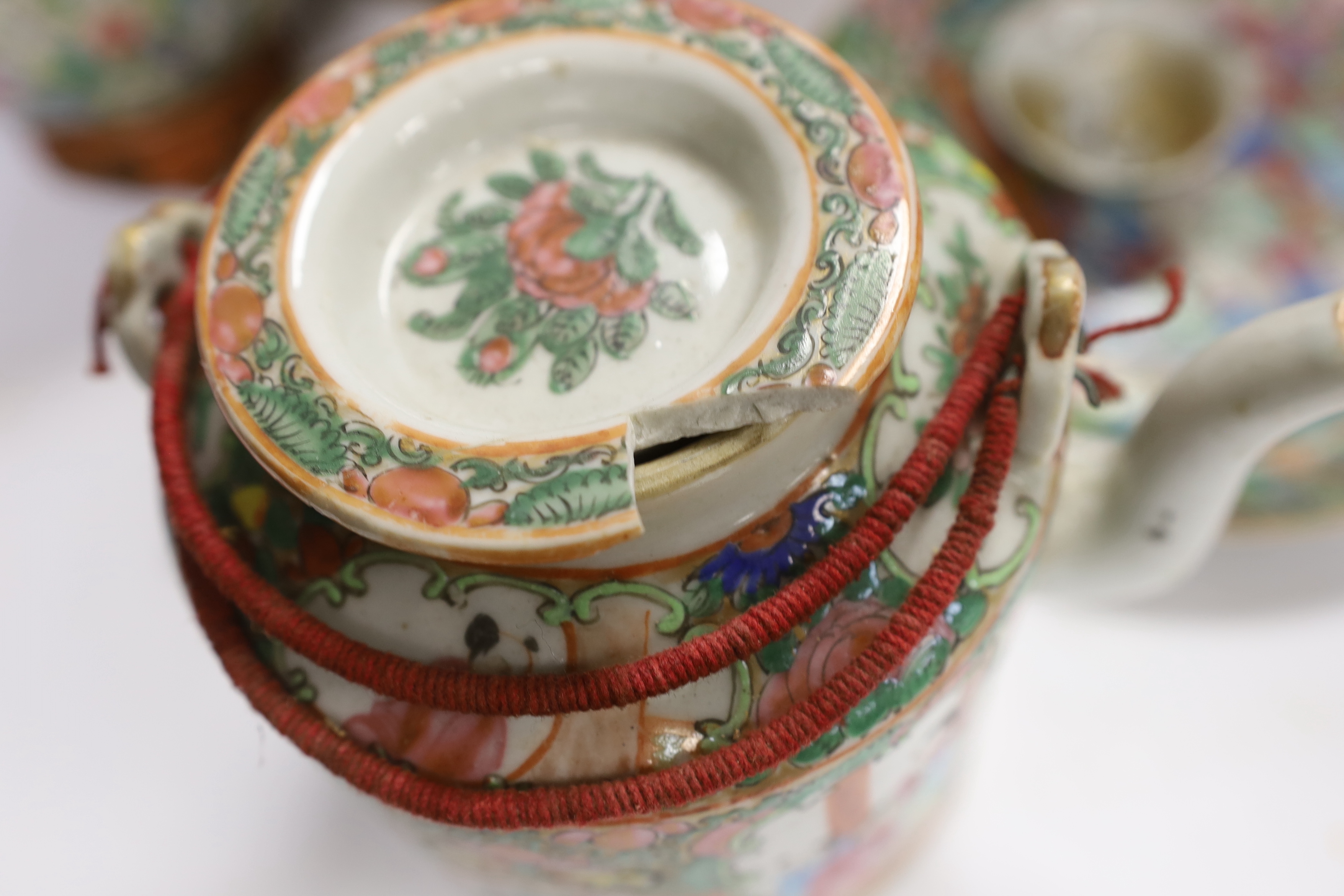 Two Chinese enamelled porcelain Millefleur vases, one with Qianlong Mark, both late 19th/early 20th century, together with two Chinese famille rose dishes and a similar basket cased tea kettle